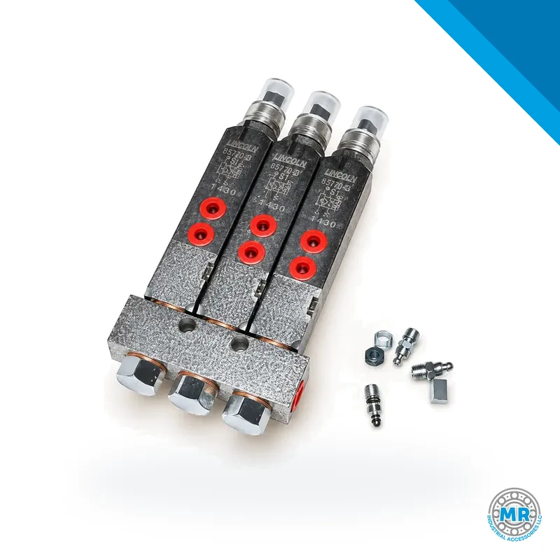 Grease manifold with three cylindrical injectors mounted on a steel block · SKF LL/85770-3